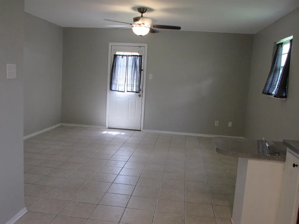 living area, photo taken from kitchen to back door