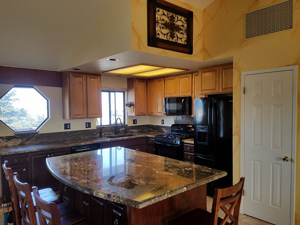 Custom Tuscan inspired BAY VIEW home. Granite countertops, gas range, microwave, new refrigerator, pantry, garbage disposal, dishwasher, and bar stools, pictured, remain with dual-sided storage island.