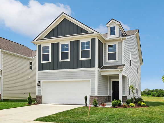 Home exterior with two tone blue siding and 2-car garage