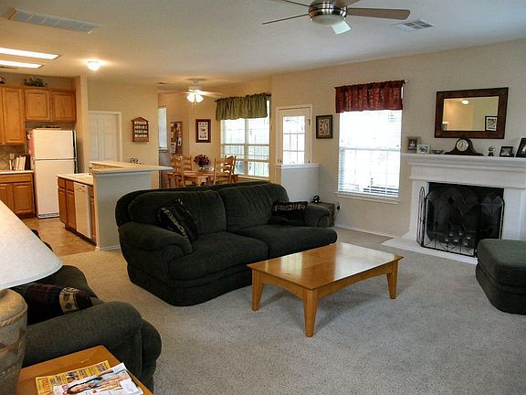 Kitchen open to the living room with fireplace.