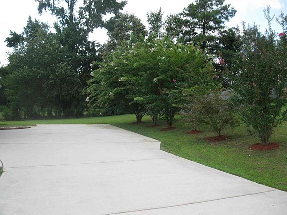 Extra wide parking pad at side of garage