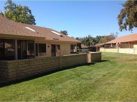 Private rear patio area with block wall fence.