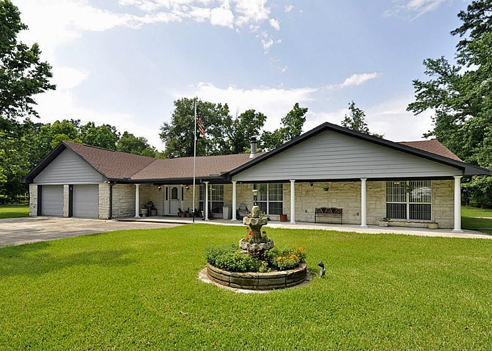 Beautiful setting! Expansive lawn leads to this one level home with an inviting front porch that run