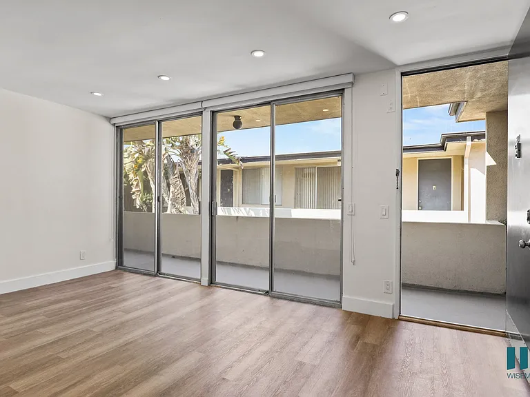 Front Entrance and Living Room with Sliding Glass Doors to Balcony