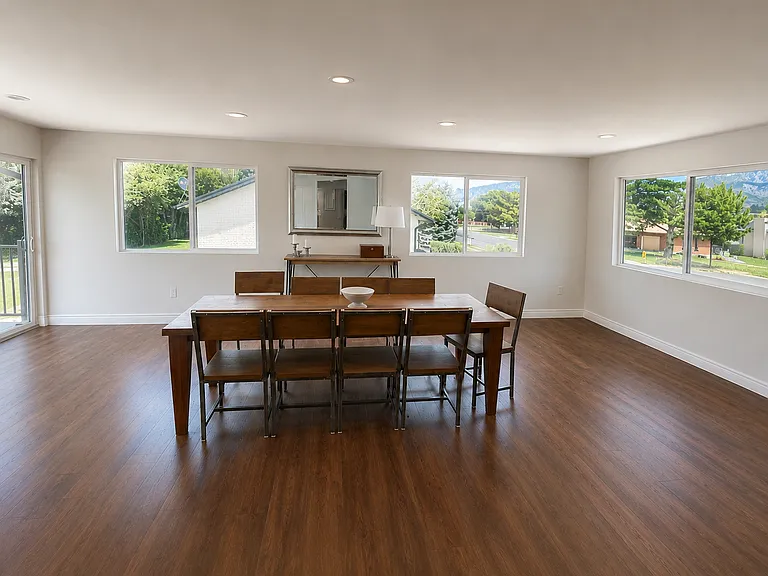 Spacious dining room with surrounding windows with a view of the surrounding mountains.