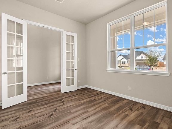 The study is quietly nestled in the front of the home and features French doors, gorgeous flooring a
