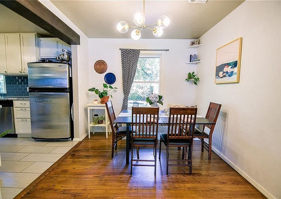 Open floorplan with beamed headers, beautiful hardwood floors, a built-in bench seat and a completely renovated kitchen of your dreams! Modern light fixtures and updates! Window treatments included!