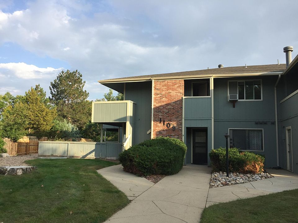 View of the building, in the back of the complex, surrounded by mature trees. Very close to open space and trails.