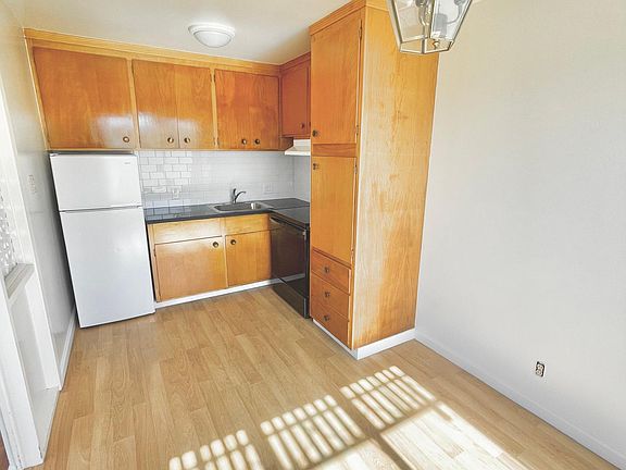Cute open kitchen with cafe / dining area that looks out to the the living room and has views of the ocean and Mt. Tam.