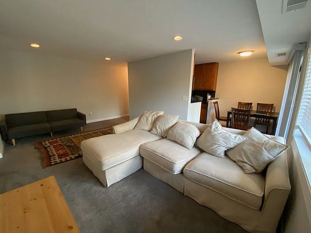 Carpeted Living Room with recessed lighting and Dining Area