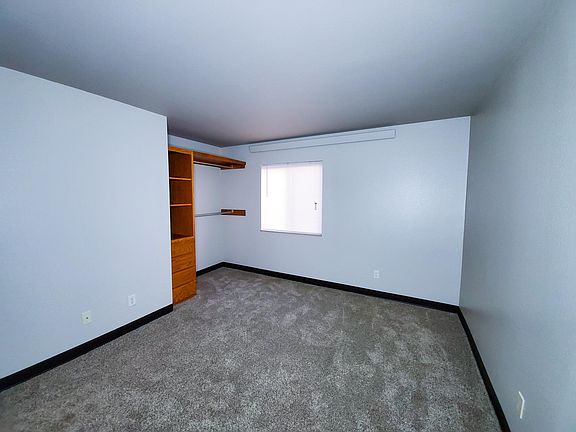Bedroom 1. Closets are open with drawer storage.