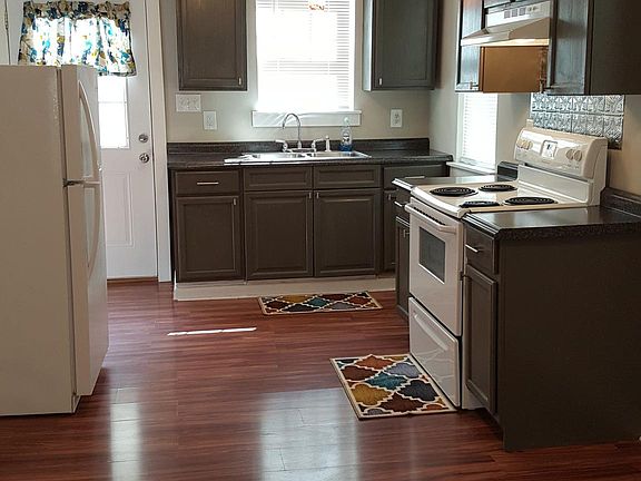 Large eat-in kitchen complete with refrigerator and stove.