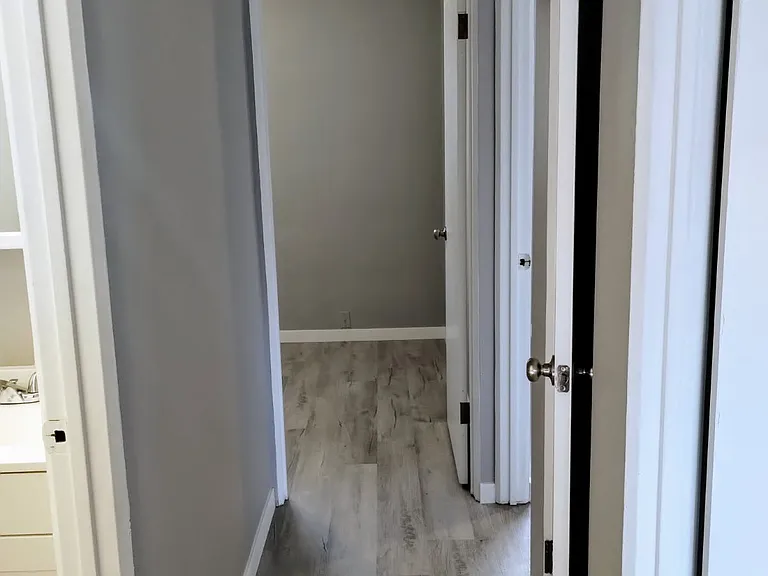 HALLWAY UPSTAIRS WITH NEW FLOORING & NEWLY PAINTED WALLS.