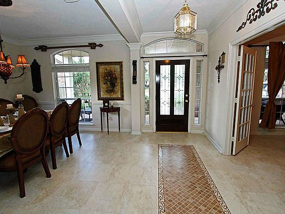 Entry with custom inlay tile accents and mahogany wood door. The tile throughout most of the downstairs is porcelain.
