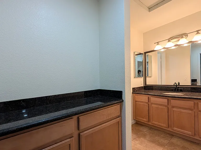 Guest bathroom with ample counter space and cabinetry
