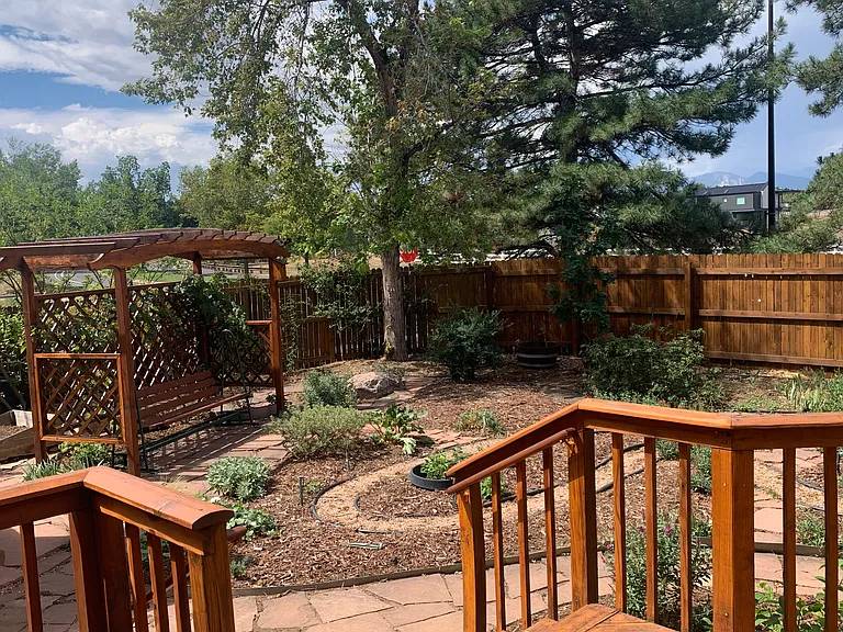 Backyard Zen garden with grape arbor and bench swing and view of the mountains