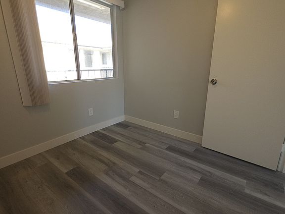 similar flooring. Unit 9's bedroom is larger and has a full closet.