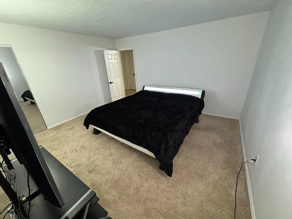 King-size platform bed with ample space for additional furniture. - Five Oaks Dr