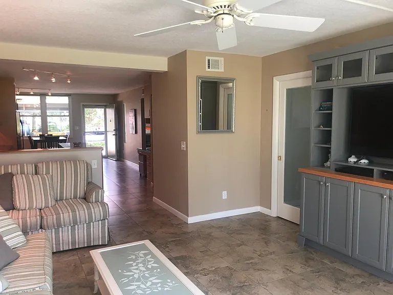 Gathering Room with Custom Entertainment Center; pocket door with beaded frosted glass insert