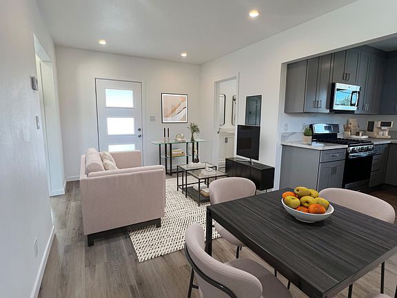 Cozy living and dining area designed with open concept in mind next to the kitchen.