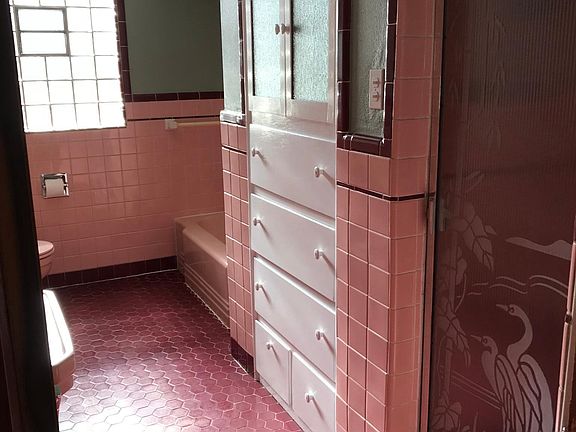 bathroom with tub and shower