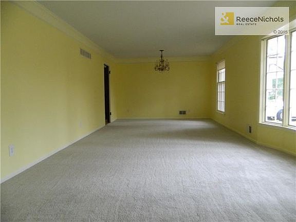 HUGE living room with dining room has NEW carpet, beautiful windows and an original crystal chandelier. Crown molding and freshly painted. SO MUCH SPACE!