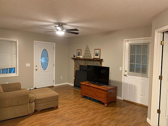 Living room with fireplace and sunroom and laundry room access