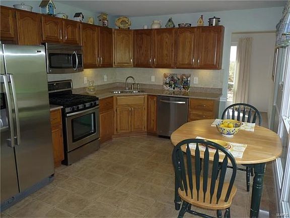 Updated kitchen with gas range, Silestone counter and stainless appliances.