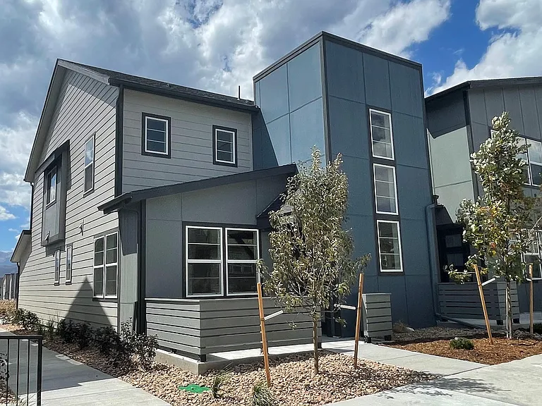 Spacious 3-bedroom end-unit floor plan with attached 2-car garage, open-concept living area, upstairs laundry, and dedicated workspace.