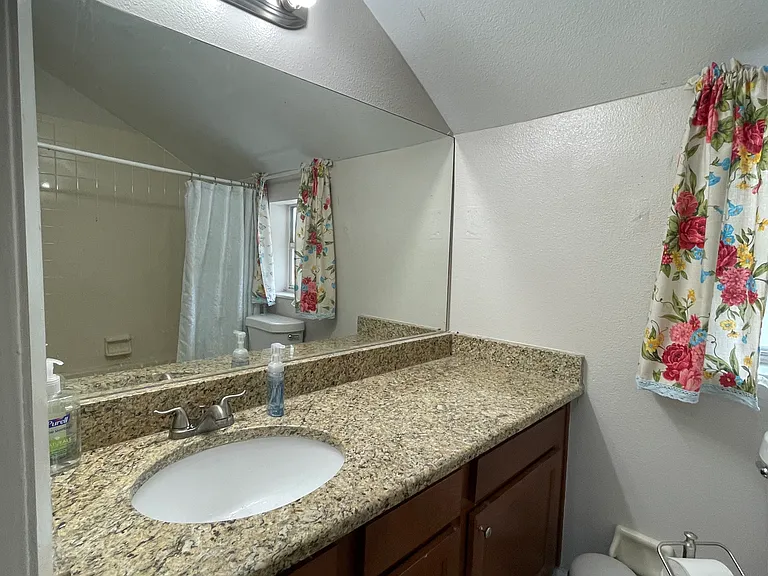 upstairs bathroom with wall mirror.