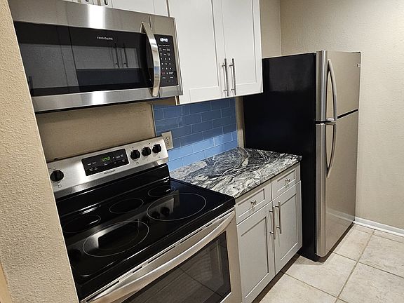 stainless appliances and granite counters. comes stocked with dishes, pots, pans, small appliances- everything you need