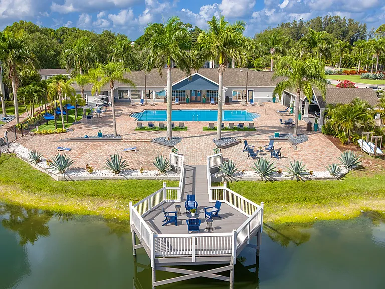 Relax in style at Grand Oaks with a sparkling pool, palm-lined sun deck, and a peaceful lakeside gathering spaceperfect for unwinding or socializing.