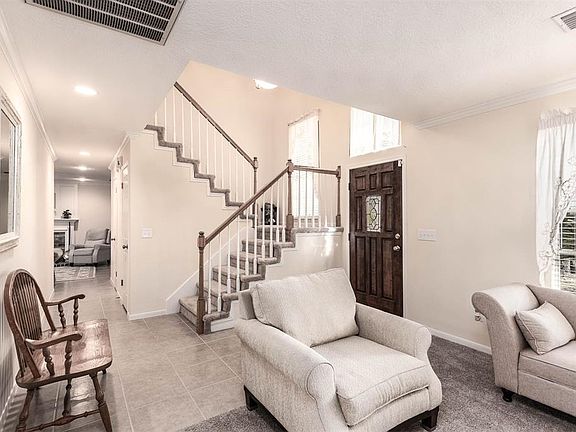The second floor balcony overlooks the den and entryway with ample lighting!