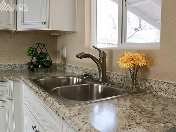 Lots of light from Kitchen window looking into backyard.  New counter tops, sink