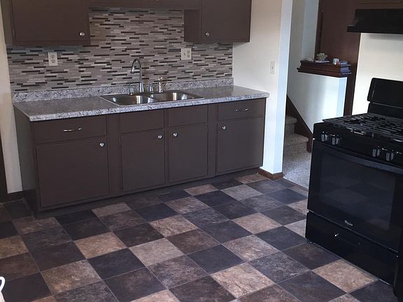 kitchen with new mosaic backsplash countertops and sink