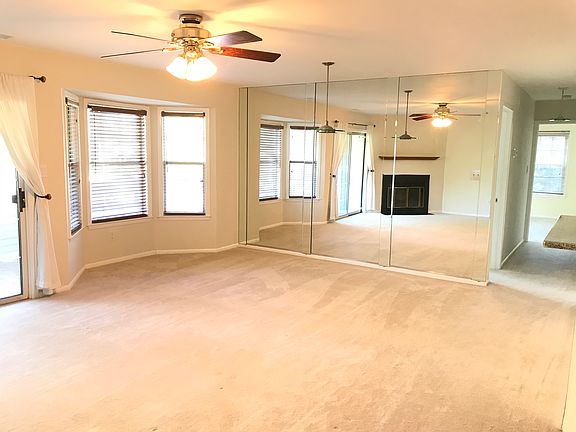 Open floor living / dining area with beautiful fully mirrored wall