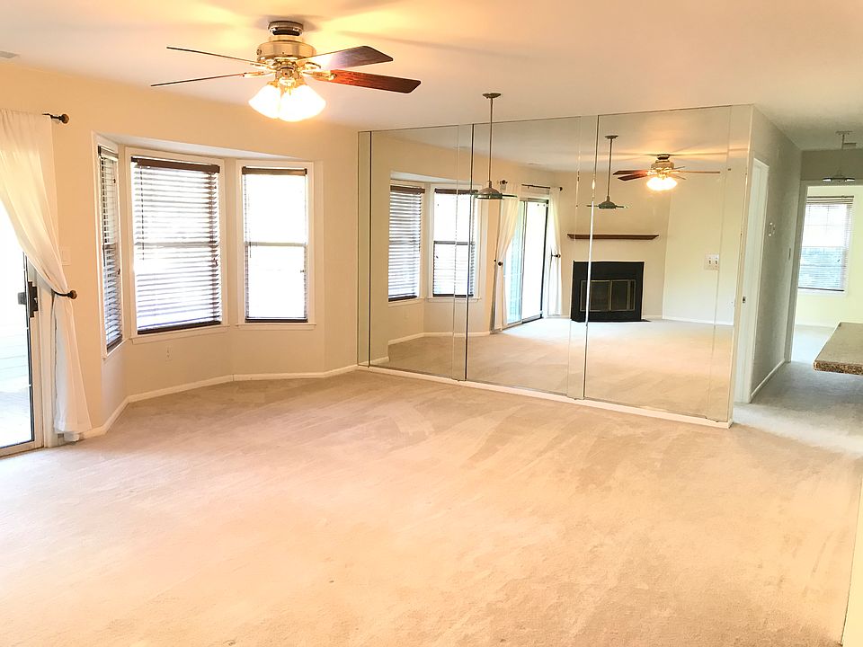 Open floor living / dining area with beautiful fully mirrored wall