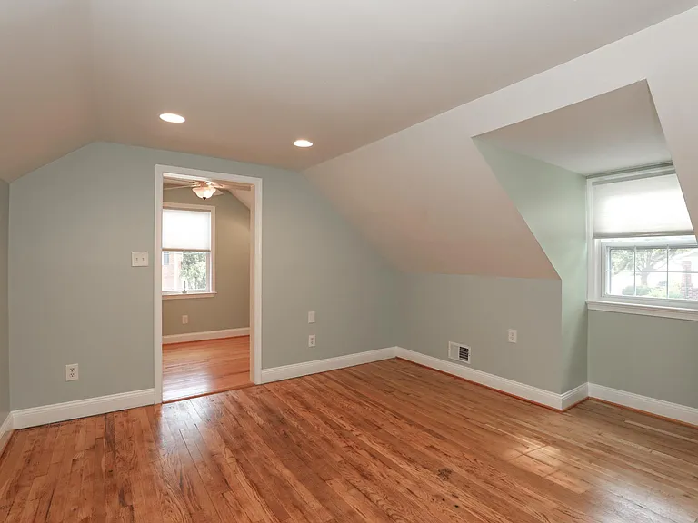 Upper bedroom from opposite angle showing room layout.