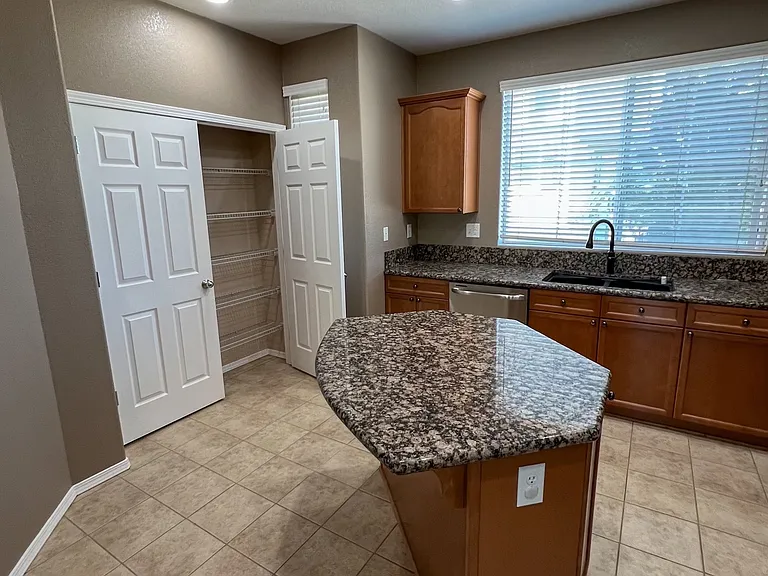 Kitchen island, pantry and sink area.