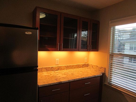 granite countertop with drawer base cabinets and glass upper cabinets
