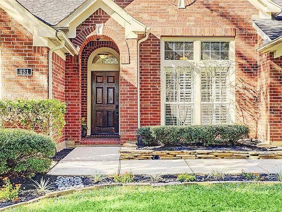 Beautiful bricked entry and a welcoming warm wooden door..