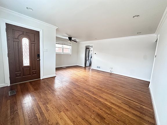 Spacious open-concept living and dining area with beautiful hardwood floors and abundant natural lighting