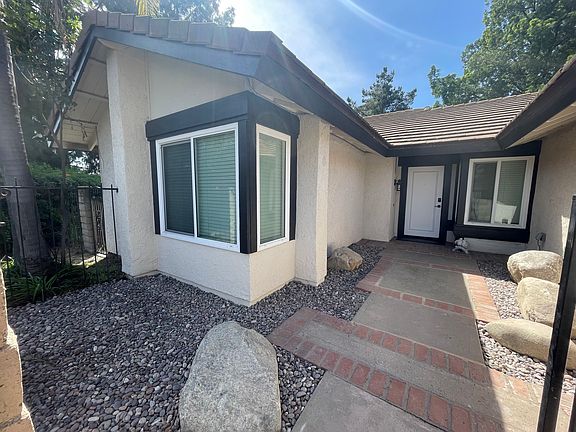ENCLOSED FRONT DOOR ENTRANCE- freshly painted door, brand new exterior motion sensors lights for safety and new door lock keypad/knobs