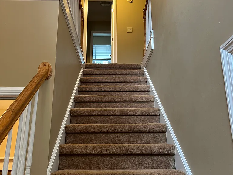 stairway from entry up to 2nd floor. Full bathroom at the top.