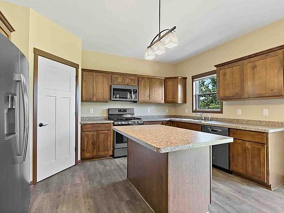 Very nice kitchen with GE slate colored kitchen appliances.