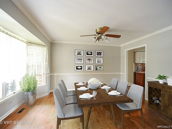 The floor to ceiling bay window brightens up the formal eating space.