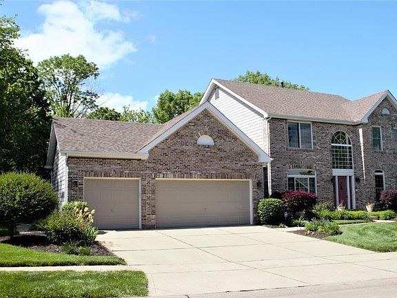 Custom landscaping featuring seasonal flowers and newer exterior lighting welcome you as you pull in to the driveway.  Keep your yard green all summer with the in ground sprinkler system.