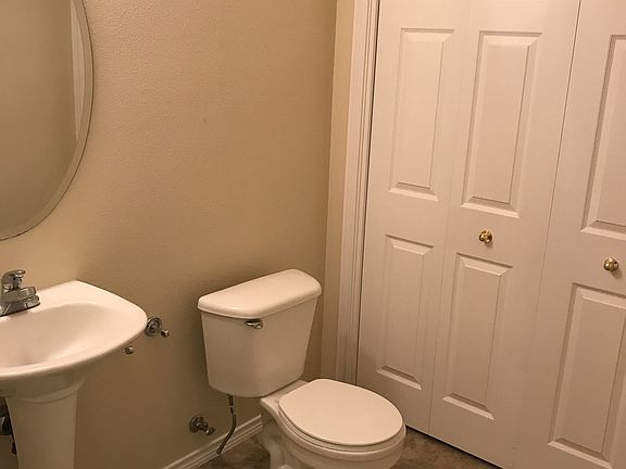 Powder room with washer and dryer behind bi-fold doors
