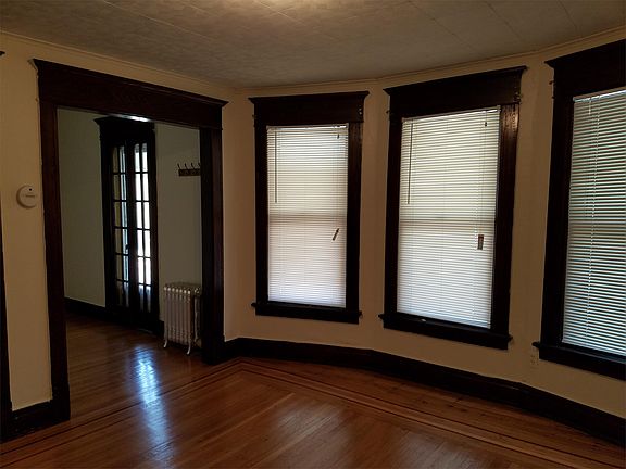 Living room-side room with french door leading to top porch, bay windows and newly sanded floors.