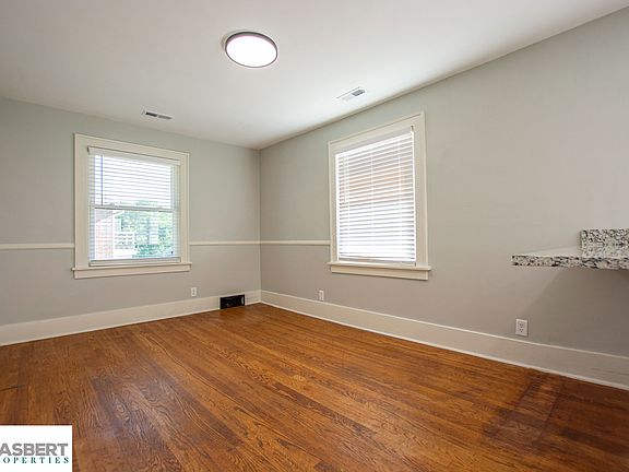 Living room with large windows and a coat closet